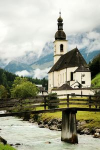 Church by tree against sky