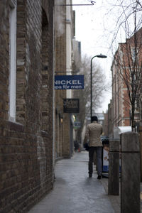 Man walking on snow covered city in winter