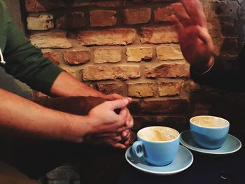 Close-up of hand holding coffee cup