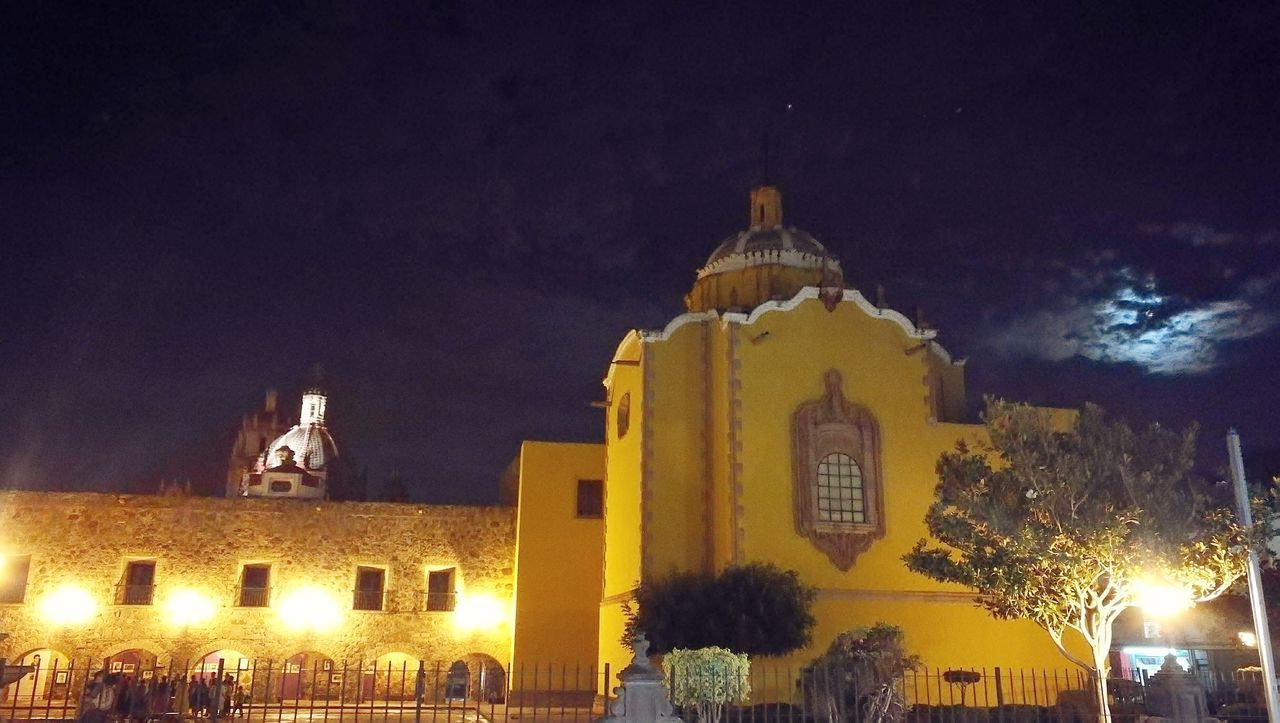 LOW ANGLE VIEW OF ILLUMINATED CHURCH AT NIGHT