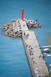 High angle view of people on beach by sea against sky