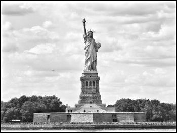 Low angle view of statue of liberty against sky