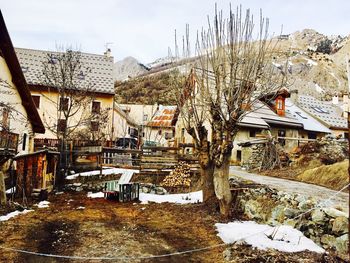 Built structure by trees against sky