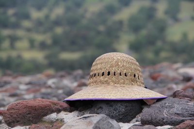 Close-up of hat on rock