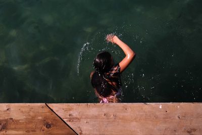 Directly above view of woman swimming in lake