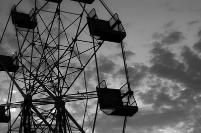 Low angle view of silhouette ferris wheel against sky