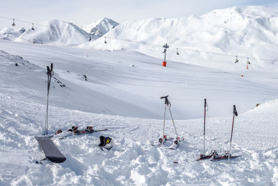 People skiing on snow covered landscape