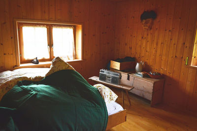 Rear view of man relaxing on bed at home