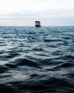 Scenic view of sea against clear sky with a boat in frame