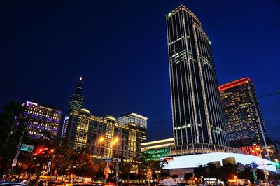 Low angle view of skyscrapers lit up at night