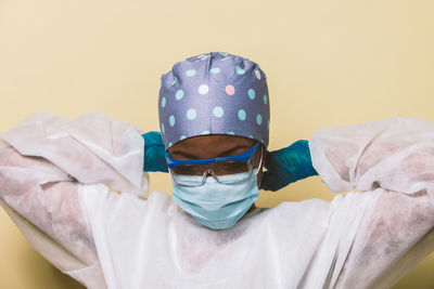 Doctor wearing mask against blue background