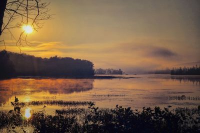 Scenic view of lake against orange sky