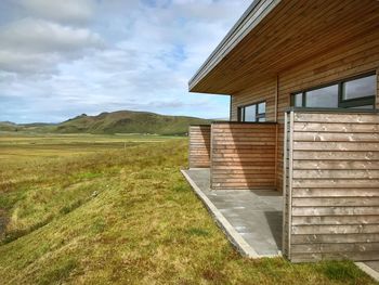 Built structure on field against sky