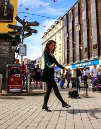 Full length of woman on street in city