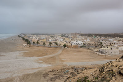 Panoramic view of beach and buildings against sky