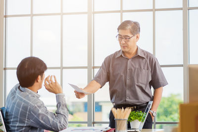 Side view of business colleagues working at office