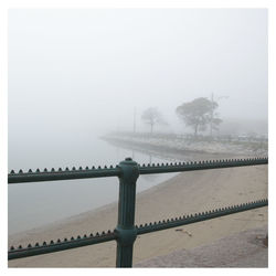 Bridge over river in foggy weather