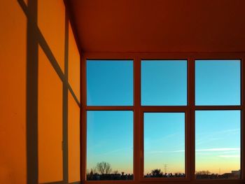 View of sky seen through window during sunset