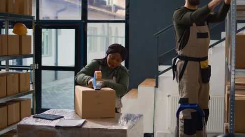 Side view of woman working in library