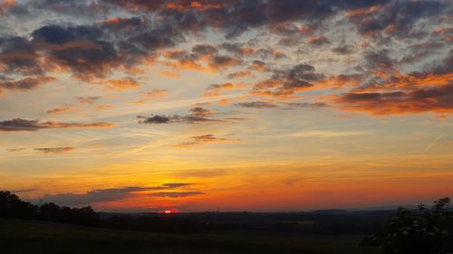 Scenic view of silhouette landscape against romantic sky at sunset