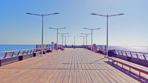 Pier on sea against clear sky