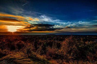 Scenic view of land against sky during sunset