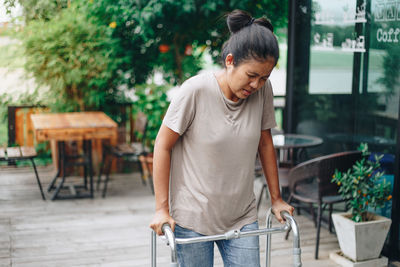 Woman looking at camera while sitting on table