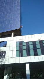 Low angle view of modern building against clear blue sky