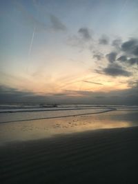 Scenic view of beach against sky during sunset