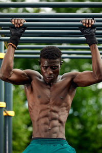 Shirtless man exercising in gym