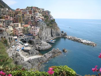 High angle view of townscape by sea against sky