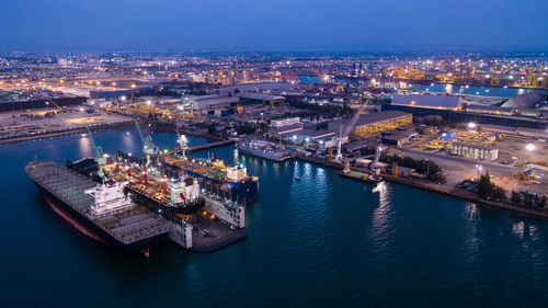 High angle view of shipping containers port illuminated  at night