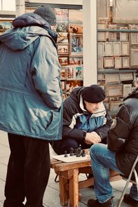 Rear view of couple sitting on the floor