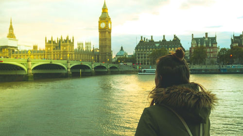 Rear view of woman standing against big ben in city