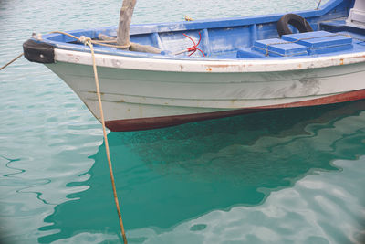 Fishing port on miyako island, okinawa, japan. a large catch of fish under a fishing boat.