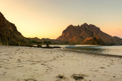 Scenic view of beach against sky during sunset
