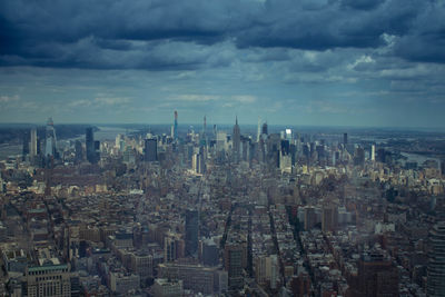 High angle view of buildings against cloudy sky