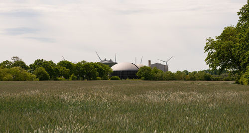 Windmill on field against sky