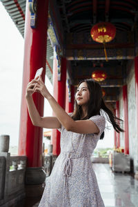 Young woman standing at home