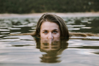 Young woman swimming in lake