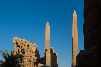 Low angle view of historic building against blue sky