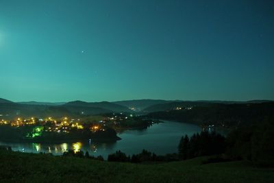 Scenic view of illuminated mountains against clear sky at night