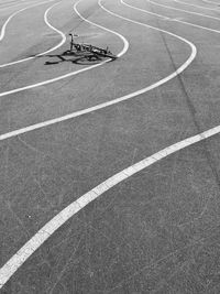 High angle view of bicycle on street with road markings