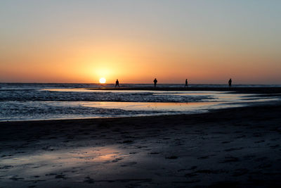 Scenic view of beach against sky during sunset