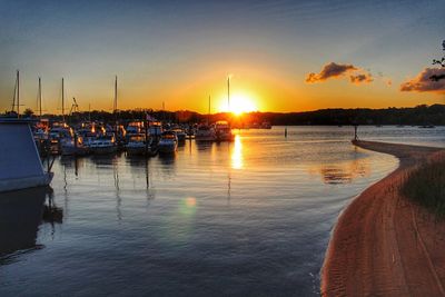 Sailboats in marina at sunset