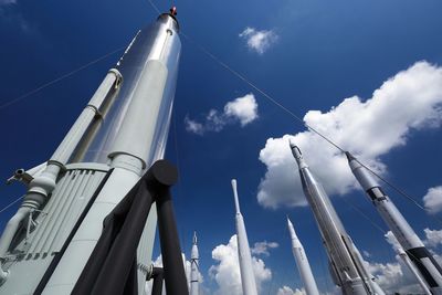 Low angle view of rockets against sky at kennedy space center in cape canaveral