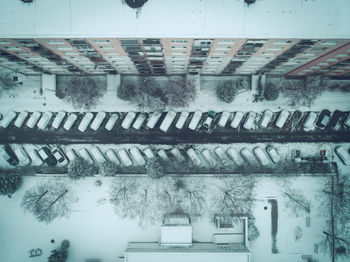 Aerial view of snow covered cars parked on parking lot