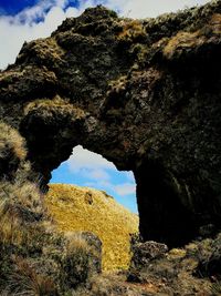 Low angle view of rock formation against sky