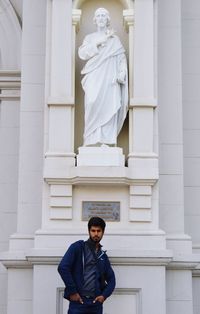 Low angle view of man standing against building