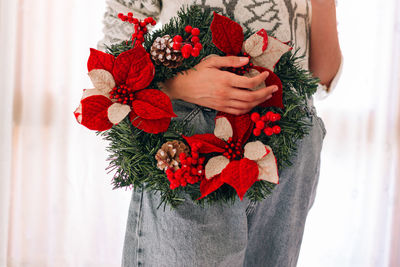 Close-up of person holding red rose